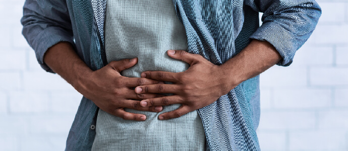 a person holding stomach in pain