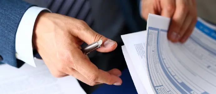 man sifting through forms
